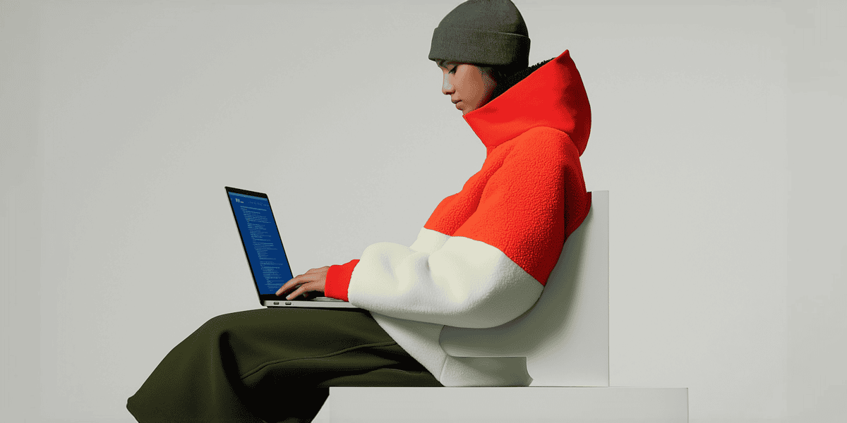 Person in Color Blocked Jacket with Laptop