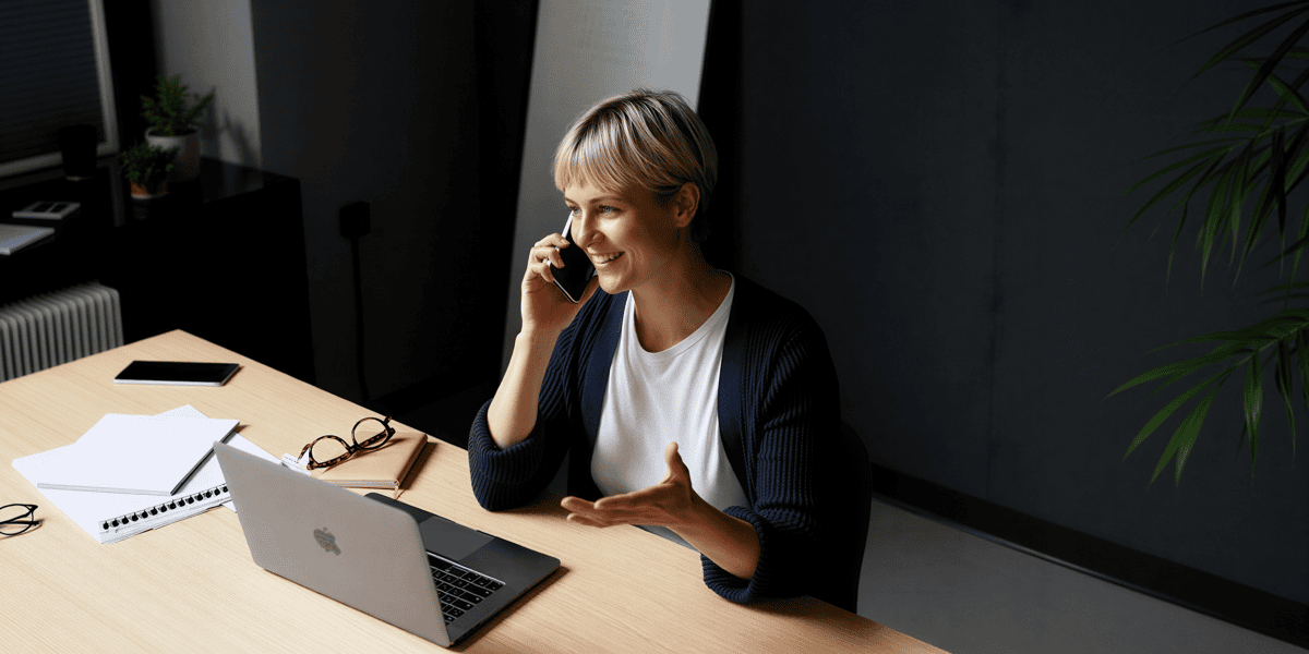 Woman on Phone at Desk
