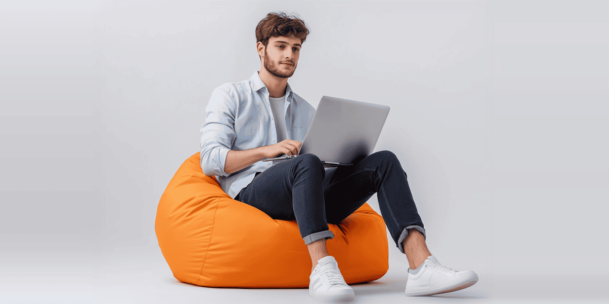 Young Man on Bean Bag with Laptop