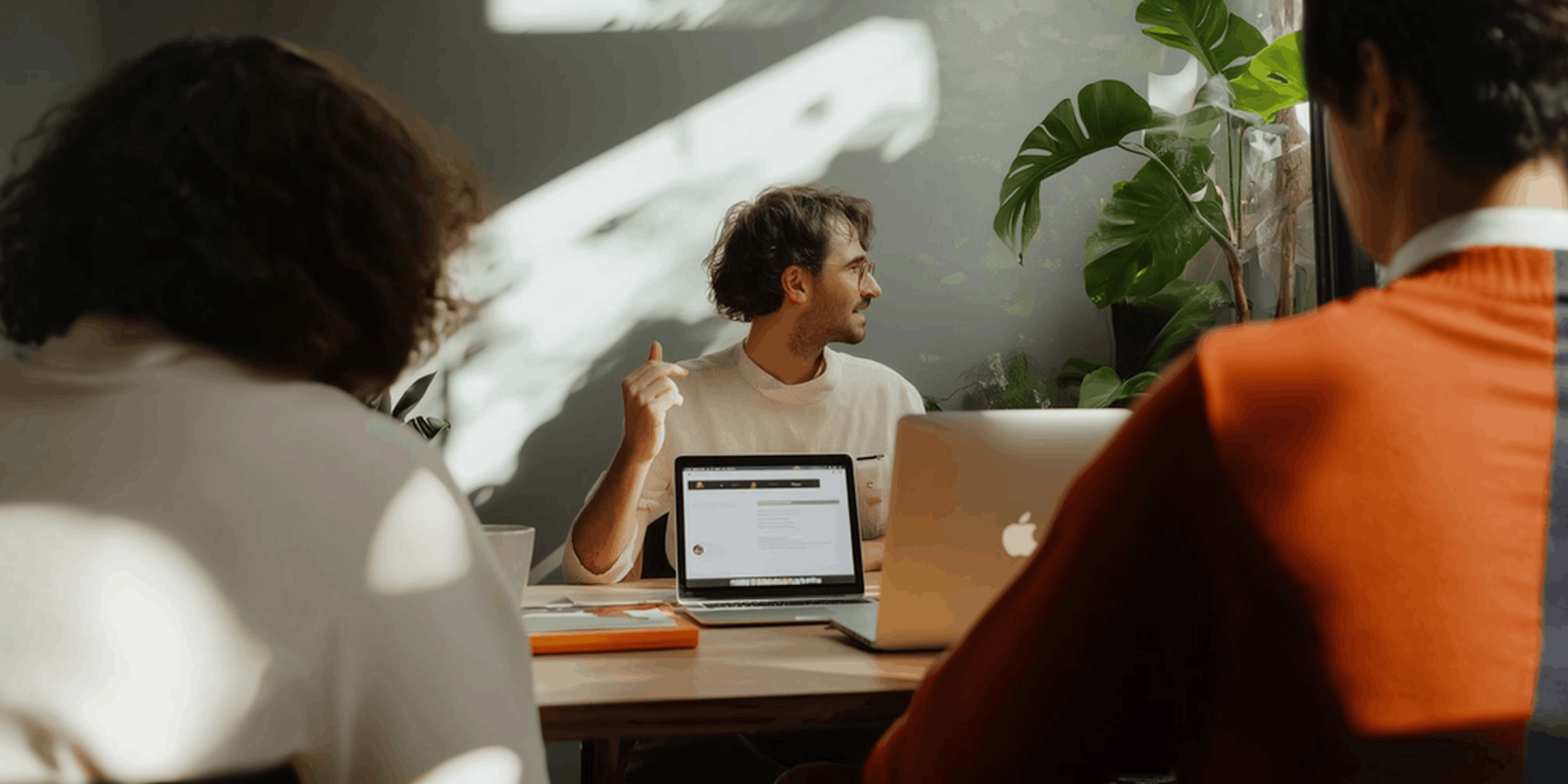 Three marketers reviewing affiliate program commission structures together at a shared desk